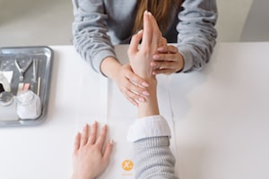 woman getting her nails looked at